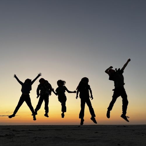 A family jumping for joy in the Makgadikgadi Salt Pans