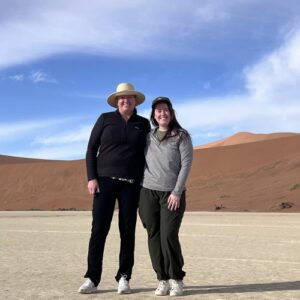 Two women standing in Deadvlei.