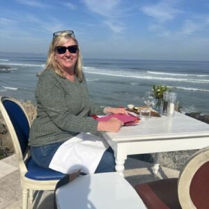 A woman having lunch near the ocean.