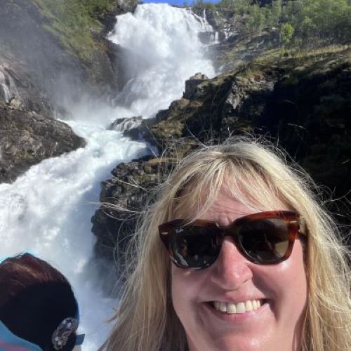 Joleen in front of a waterfall in Norway.