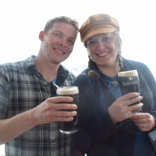 A couple holding Guinness beers.