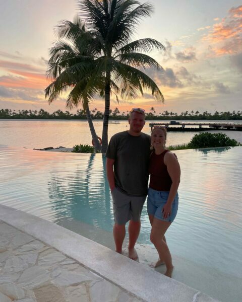 A couple in the sunset at Patina Maldives resort.