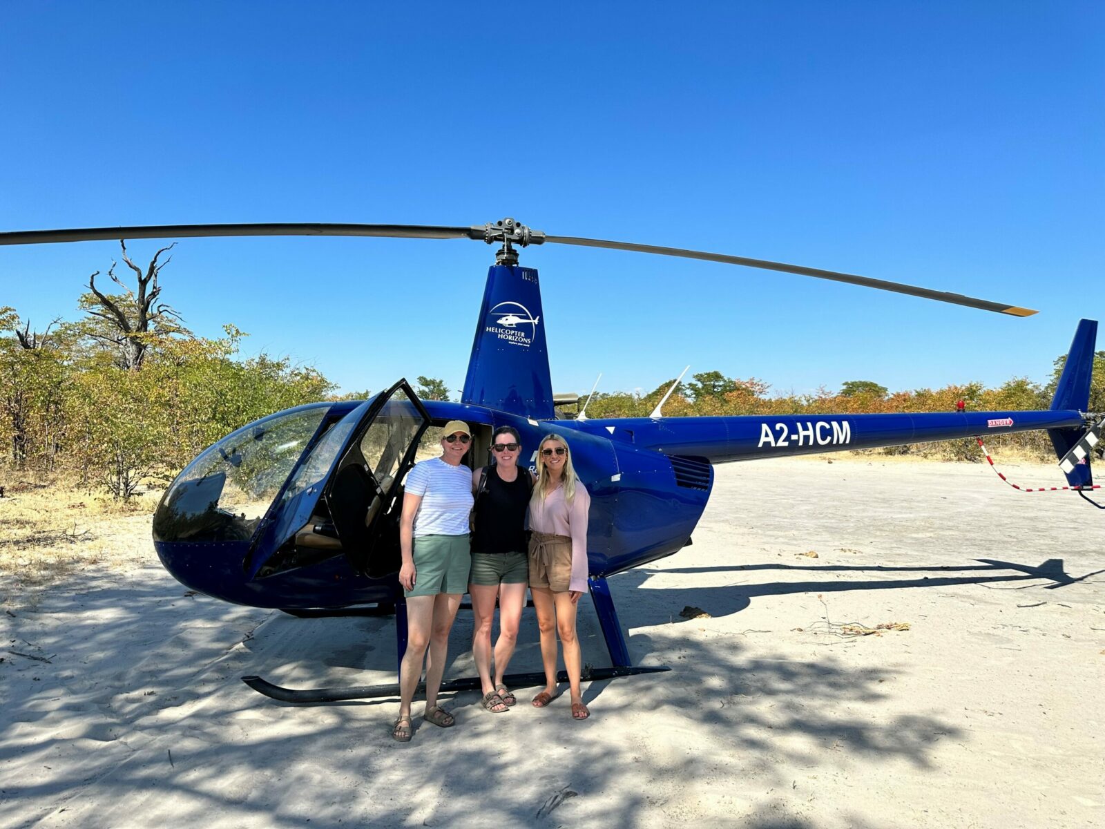 Three women getting ready for a helicopter ride in the Okavango Delta, Botswana