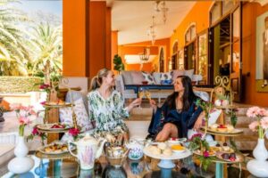 Two women smiling holding drinks