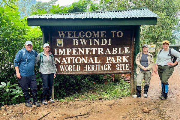 Travel advisors in front of the Bwindi sign.