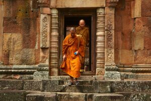 Monks in Laos, exiting a building.