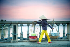 A person walking on a bridge in Hoi An, Vietnam.