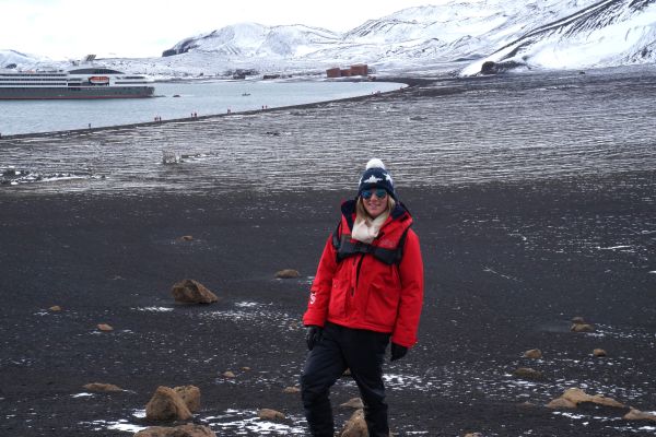 A person in a red coat in Antarctica